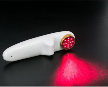 White handheld device shining red light