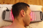 Man resting head on red light therapy pad