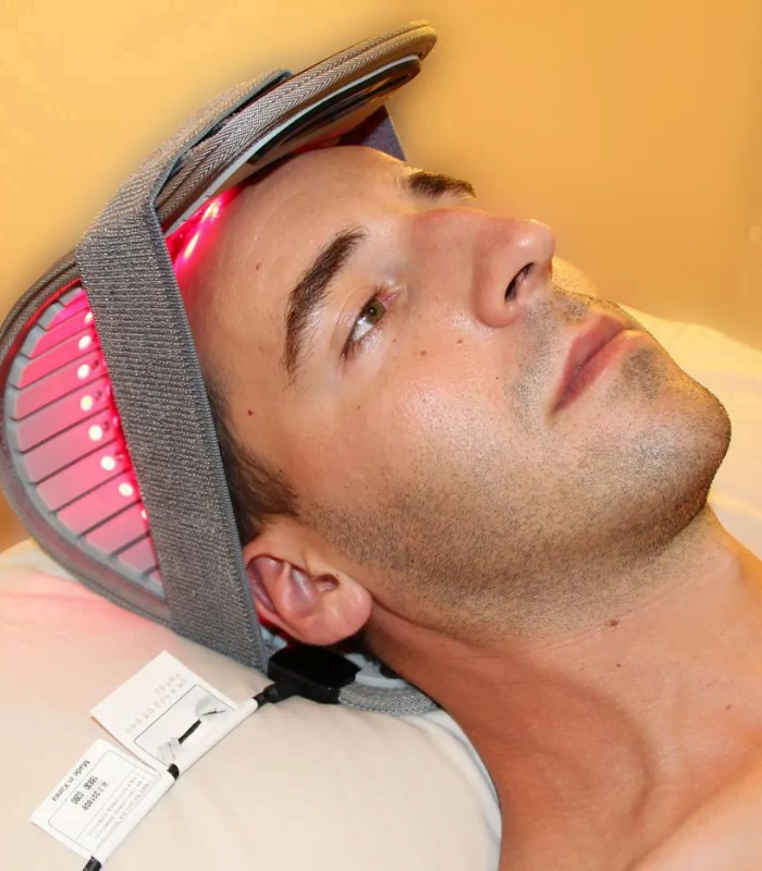 Man wearing red light therapy helmet