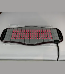Red light therapy pad with red lights and power cord on gray background