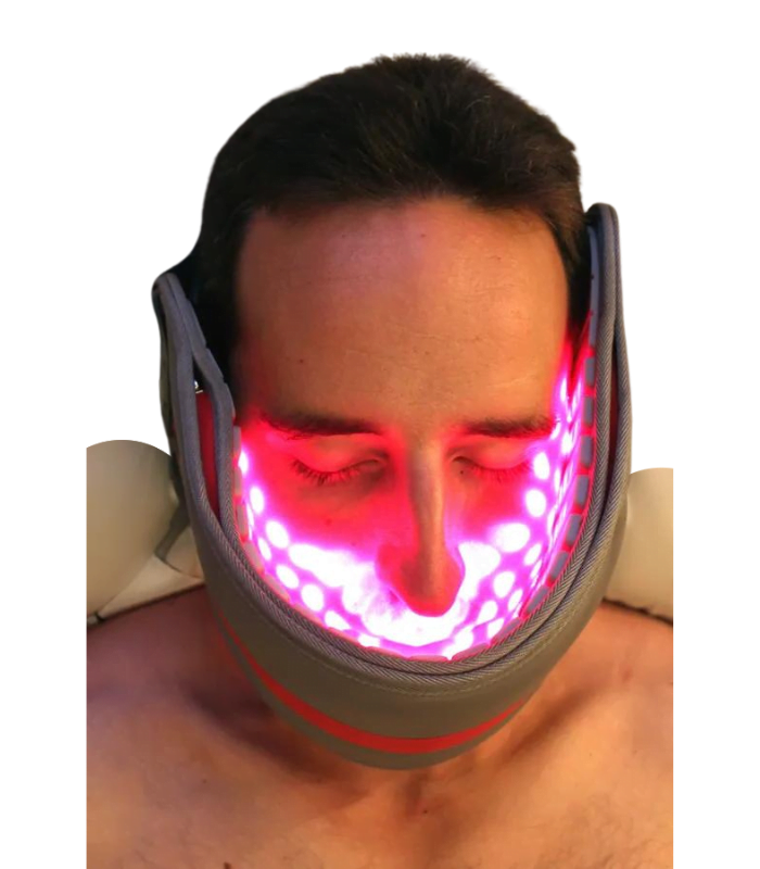 Red light therapy pad wrapped around man's neck and chin up to his nose