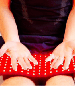 Man's hands on red light pad