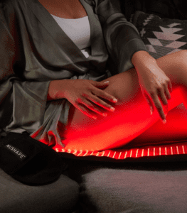 Red light shining on woman's thigh