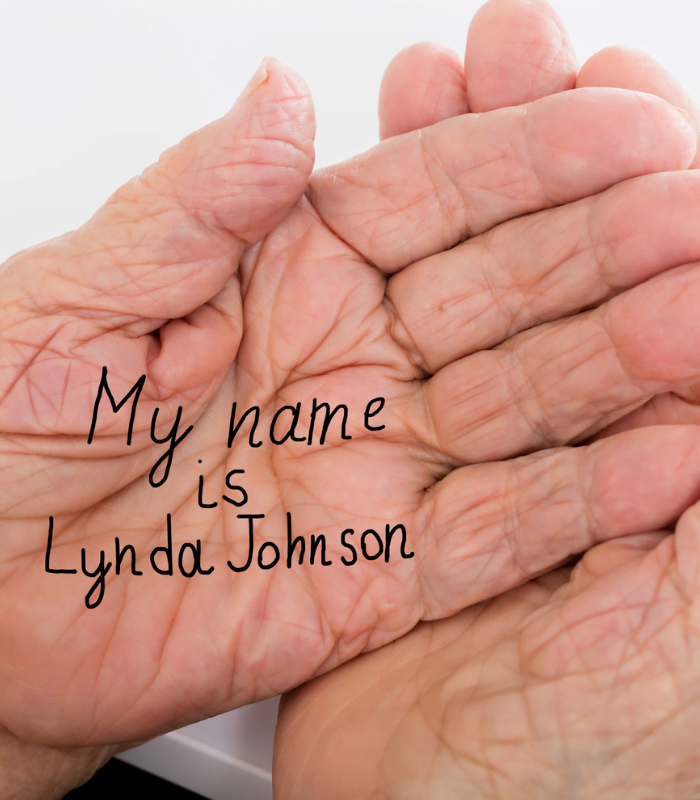 "My name is Lynda Johnson" written on an old woman's hand