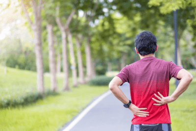 man on path with back pain