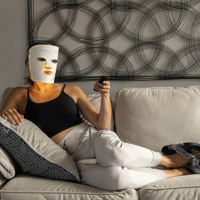 Woman relaxing wearing the NovaaLab Novaa Glow Therapy Mask 